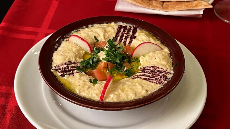 Hummus appetizer with radish and nuts