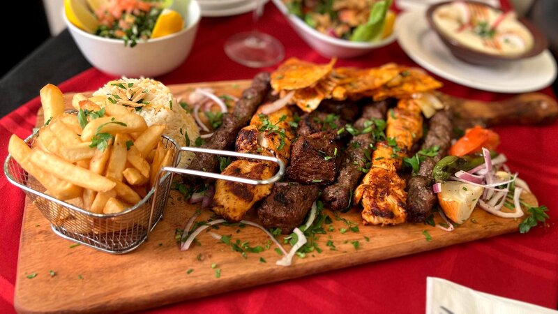 Lamb and chicken kebabs with side of french fries and rice